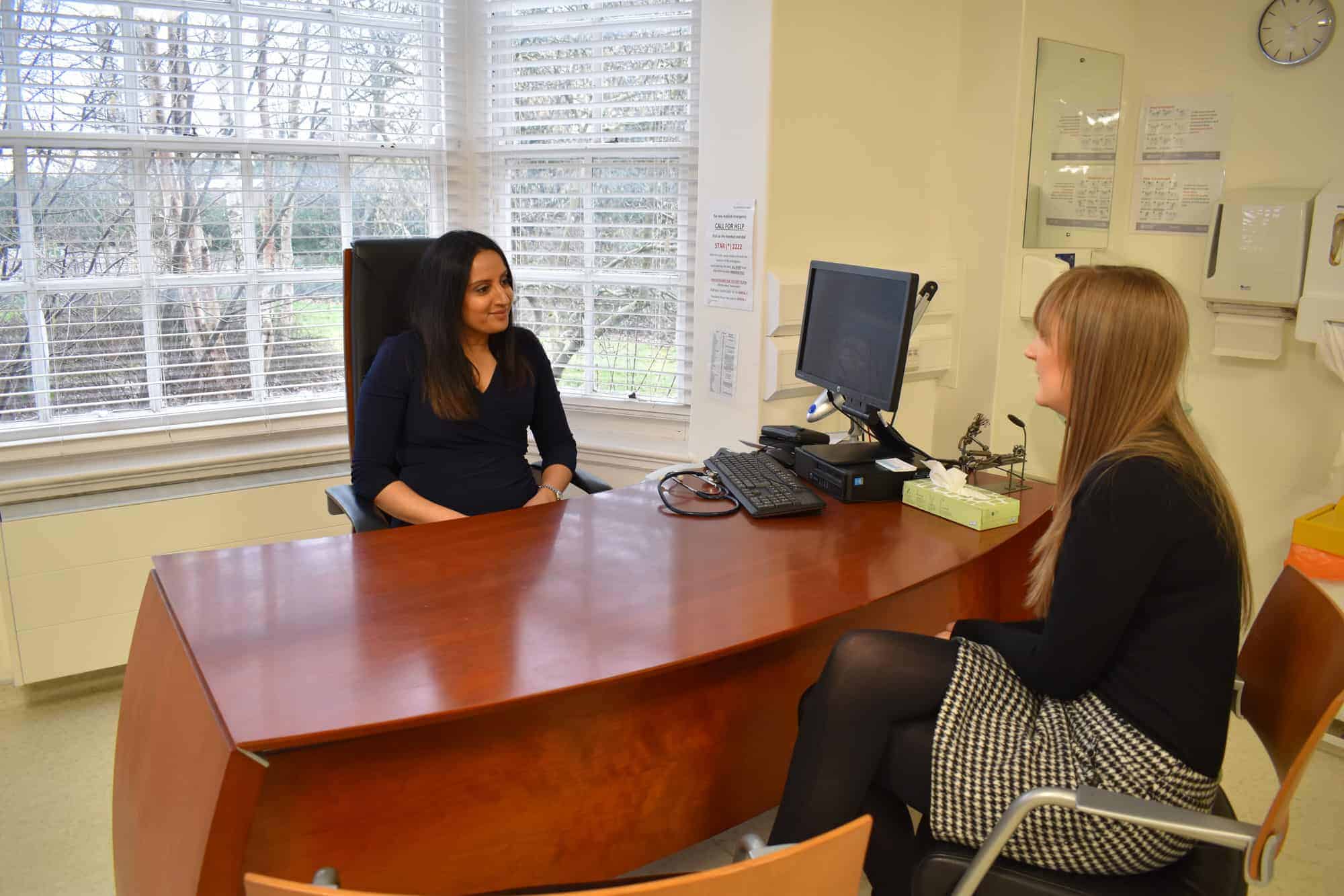 Midland Health offering Corporte Services Doctor Rupa discussing medical and corporate services with a client